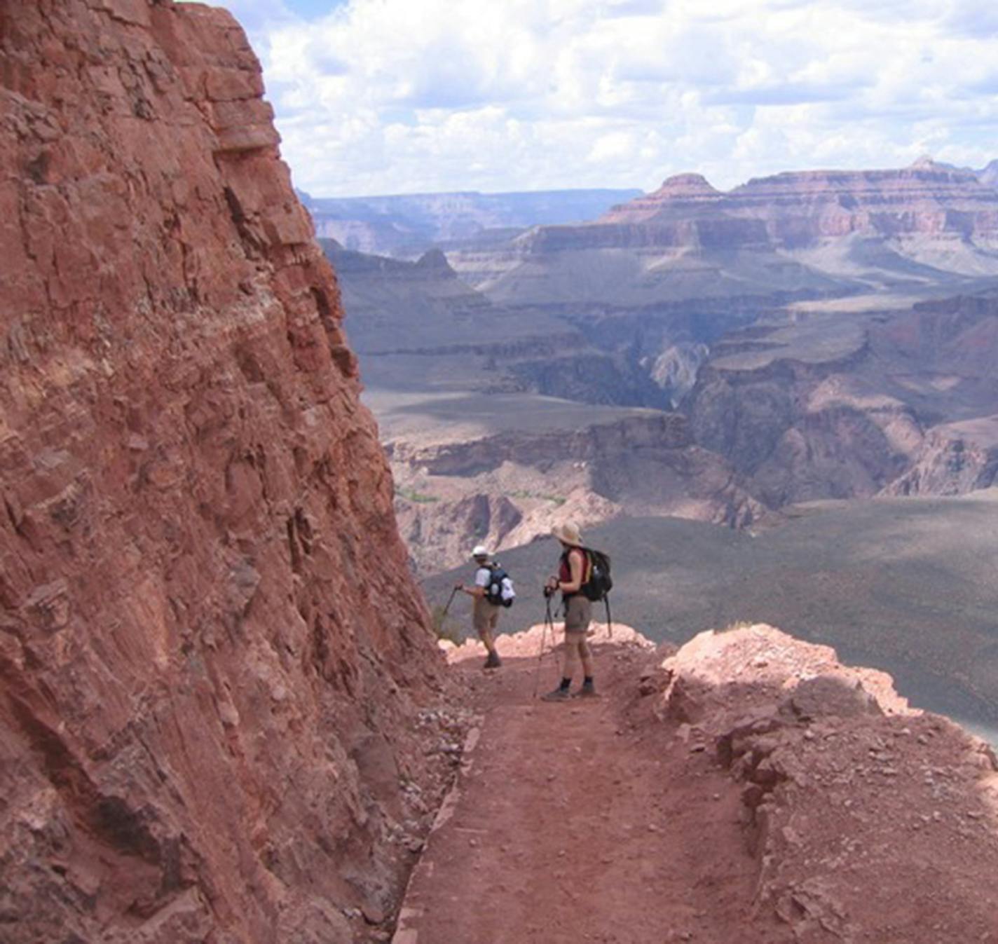 Hikers head down the trail and into the rugged Grand Canyon.