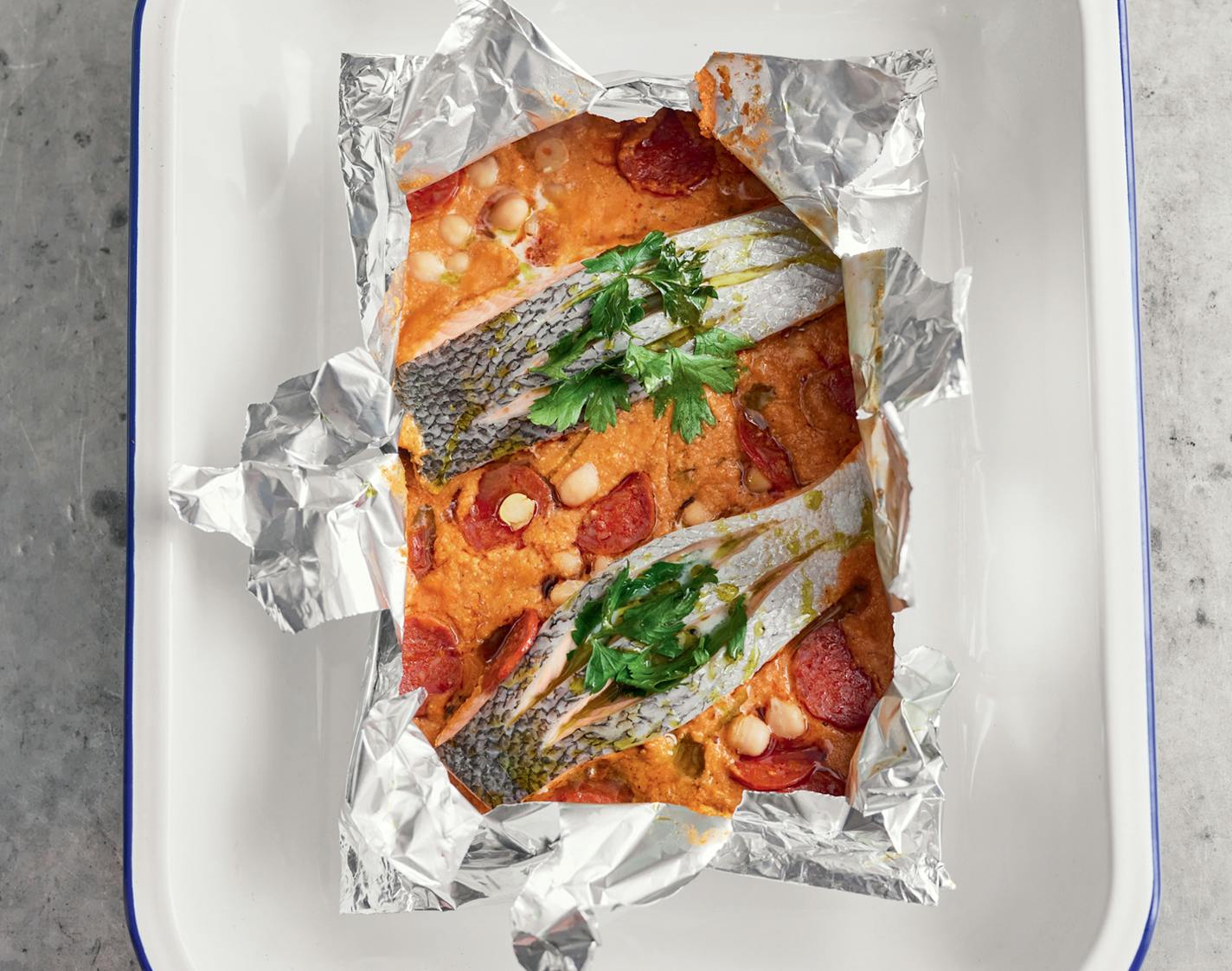 Salmon Pouches with Salmon and Chickpeas from "One: Simple One-Pan Wonders" by Jamie Oliver (Flatiron, 2023). Credit: DAVIS LOFTUS AND RICHARD CLATWORTHY