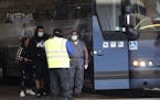 Travelers were protective face masks as they board a Greyhound bus in downtown San Antonio, Monday, March 30, 2020. Due to the COVID-19 outbreak, San 