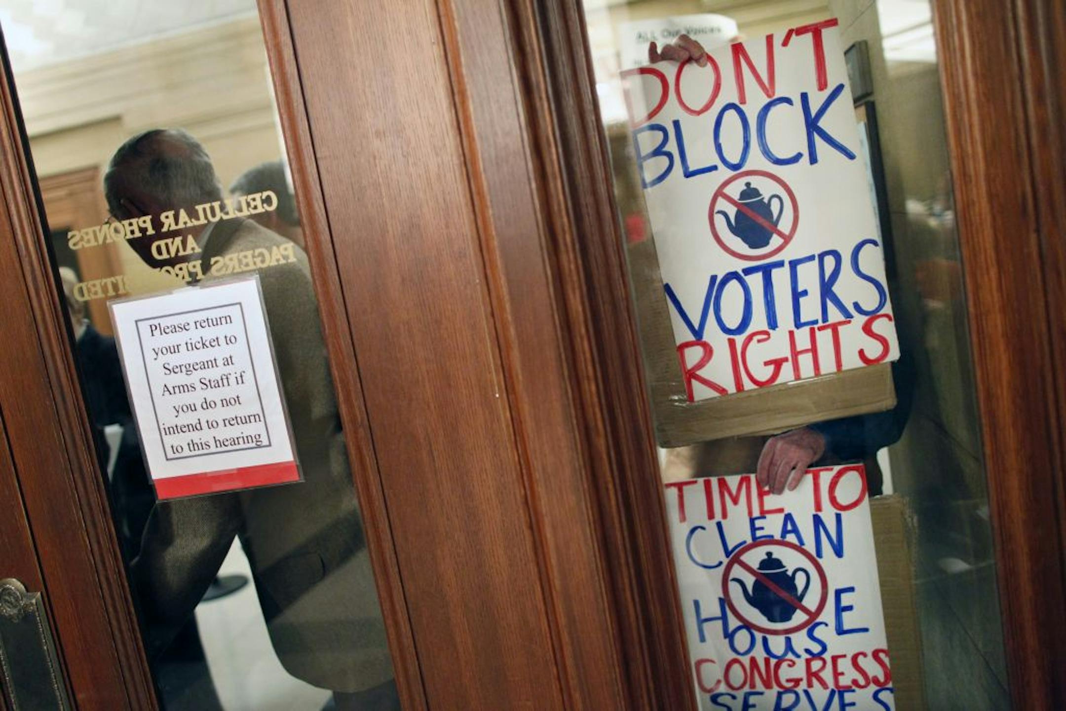 At Senate Committee on Local Government and Elections at theState Capitol, protester Jon Frasz who couldn't initially get into the meeting showed his stance on the voter ID issue.