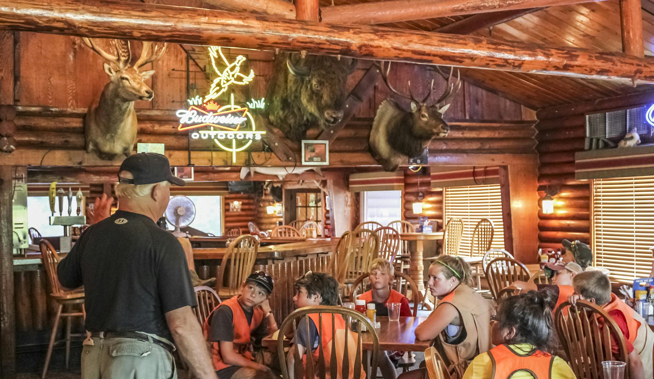 Bill Urseth, co-owner of the Minnesota Horse and Hunt Club, talks to youngsters attending a youth camp at the club in 2012. The photo was taken in the club's restaurant. Photo by Sheila Mattson