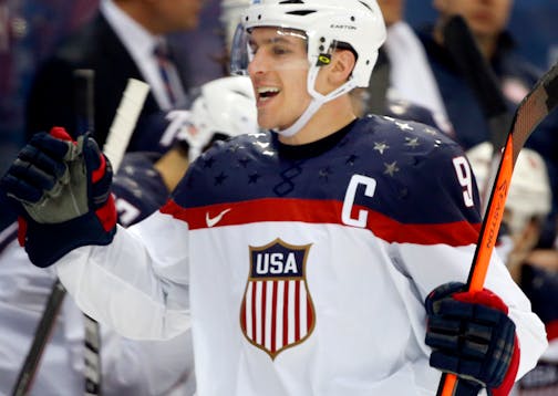 Zach Parise celebrated with teammates after he scored during the Sochi Games in 2014