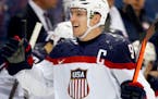 Zach Parise celebrated with teammates after he scored during the Sochi Games in 2014