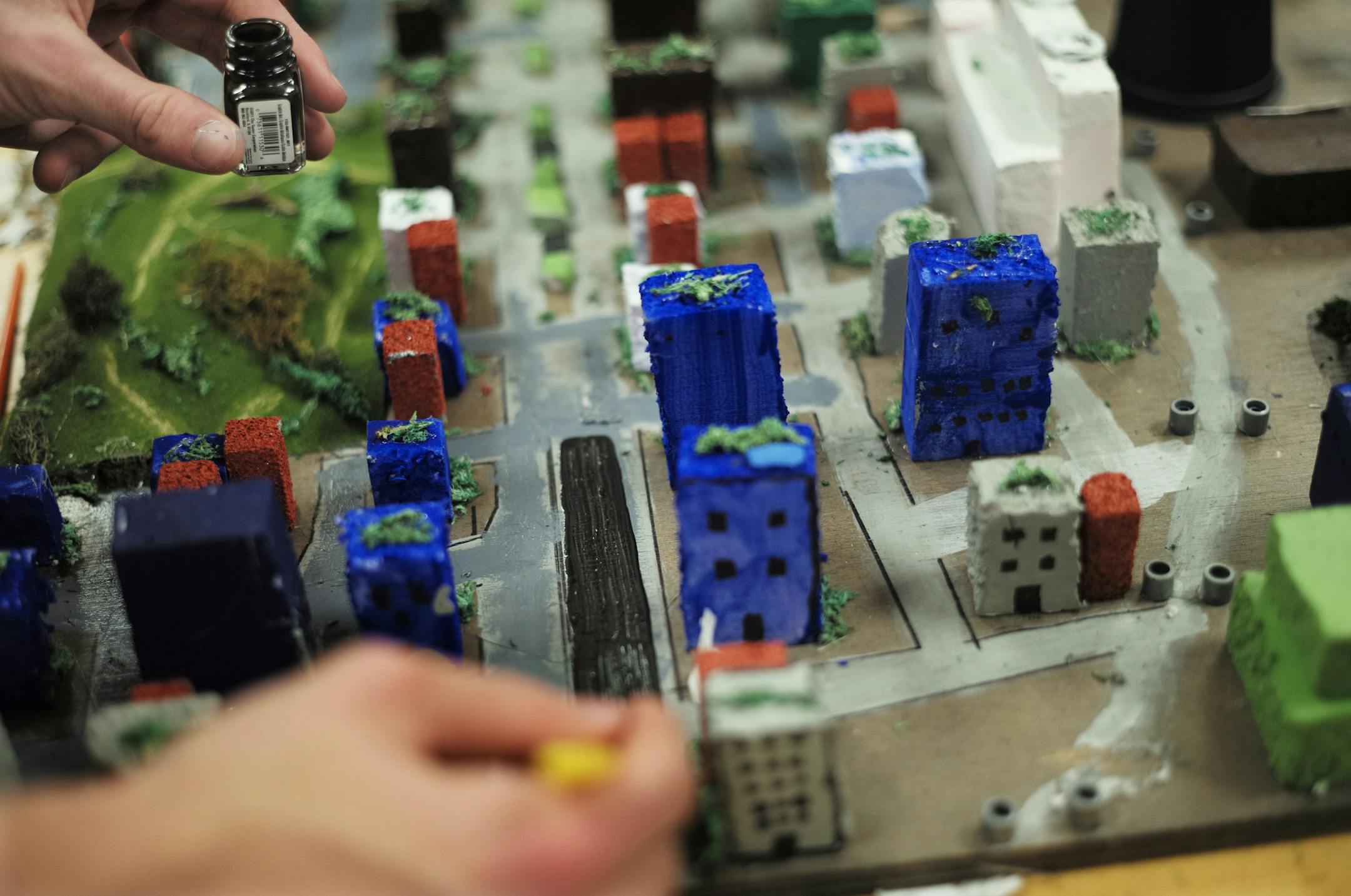 At Rosemount Middle School, Jacob Engel paints the streets of his group's model of the city "Altona" which is supplied by a Thorium nuclear reactor and geothermal wells. The competition asks students to solve global problems by designing their own vision of a city in the future. This year's focus is on transportation issues, and students use both Sim City software and real-world materials to design their model..]rtsong-taatarii@startribune.com