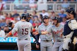 The Tigers' Carson Kelly greets his teammates at home after hitting a grand slam in the third inning against the Twins at Target Field on Wednesday.