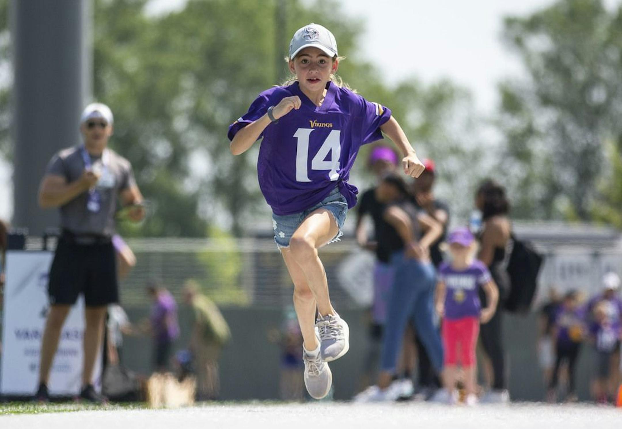 Adrienne Wall runs a 40 yard dash at one of the "Kid's Combine" stations in the Kid's Zone at Vikings training camp. ALEX KORMANN • alex.kormann@startribune.com The Minnesota Vikings opened up their first full day of training camp on Friday July 26, 2019 at TCO Performance Center in Eagan, MN. Doors opened to fans at 11AM to watch their favorite players practice and get excited for the 2019 NFL season.