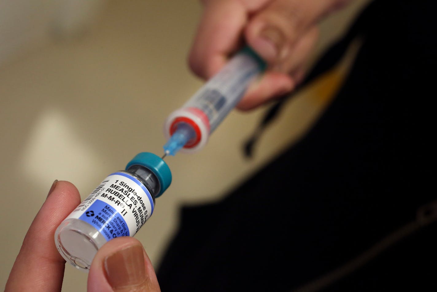 A vial containing the MMR vaccine is loaded into a syringe before being given to a baby at the Medical Arts Pediatric Med Group in Los Angeles on February 6, 2015. (Mel Melcon/Los Angeles Times/TNS) ORG XMIT: 1261895