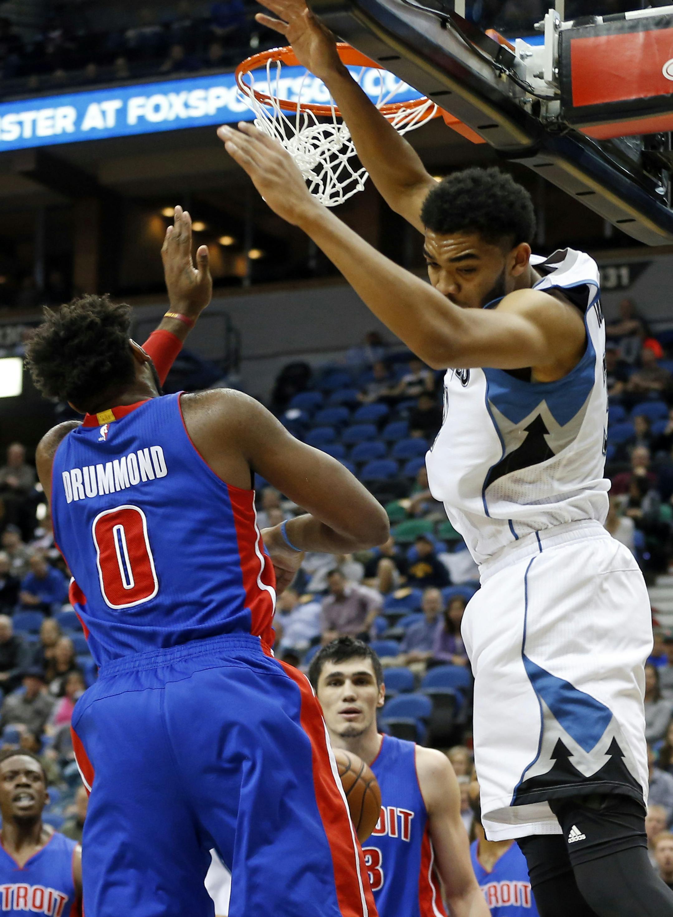 Minnesota Timberwolves’ Karl-Anthony Towns, right, completes a dunk against Detroit Pistons’ Andre Drummond in the first quarter of an NBA basketball game, Friday, Nov. 20, 2015, in Minneapolis. (AP Photo/Jim Mone)