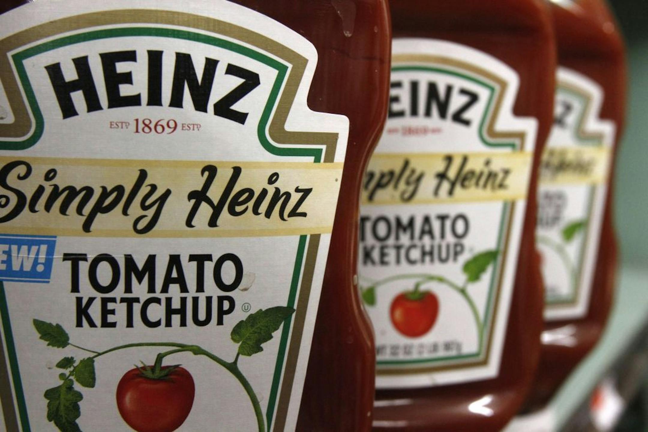 FILE - In this March 2, 2011 file photo, Heinz ketchup is seen on the shelf of a market in Barre, Vt. H.J. Heinz Co. says it agreed to be acquired by an investment consortium including billionaire investor Warren Buffett in a deal valued at $28 billion.