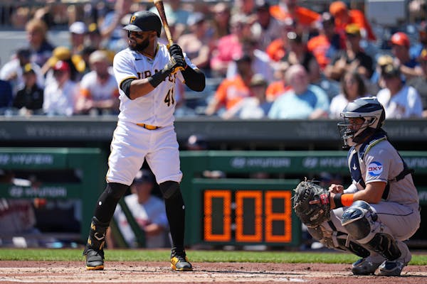 The pitch clock counts down as Pittsburgh Pirates’ Carlos Santana (41) waits for a pitch.