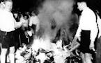 Members of the Hitler Youth participate in burning books, in Salzburg, Austria, on April 30, 1938. The burning of books that are condemned as Jewish-M