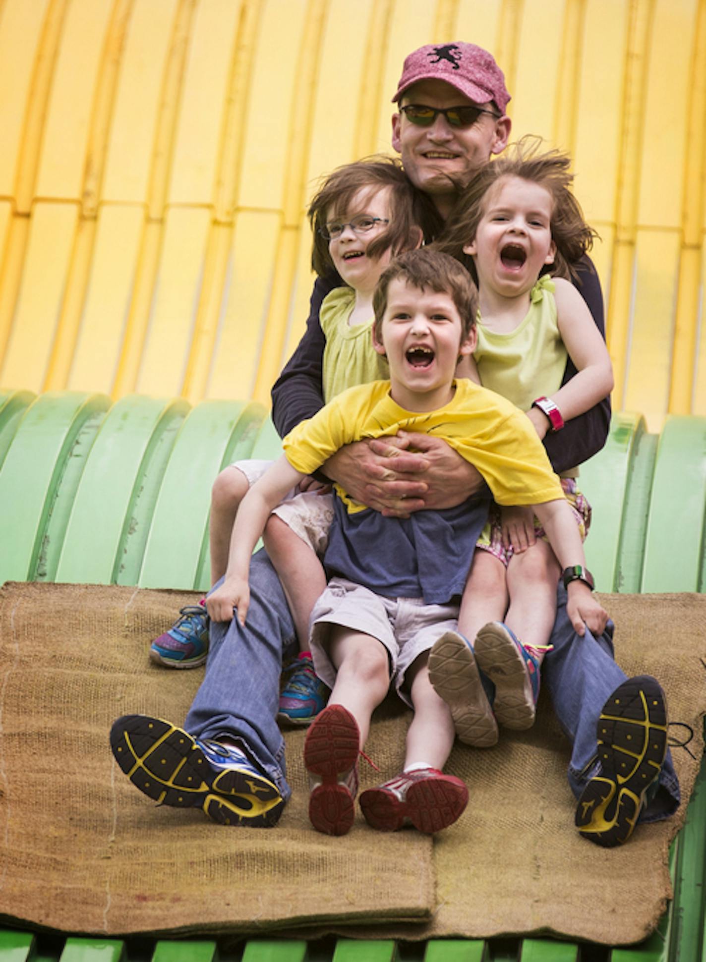 Dan Huse of Woodbury rides the giant slide with his son Calvin, 6, and twin four-year-old daughters Hana, left, and Lexi at the Minnesota State Fair on Friday, August 28, 2015. ] LEILA NAVIDI leila.navidi@startribune.com / ORG XMIT: MIN1508281647280350