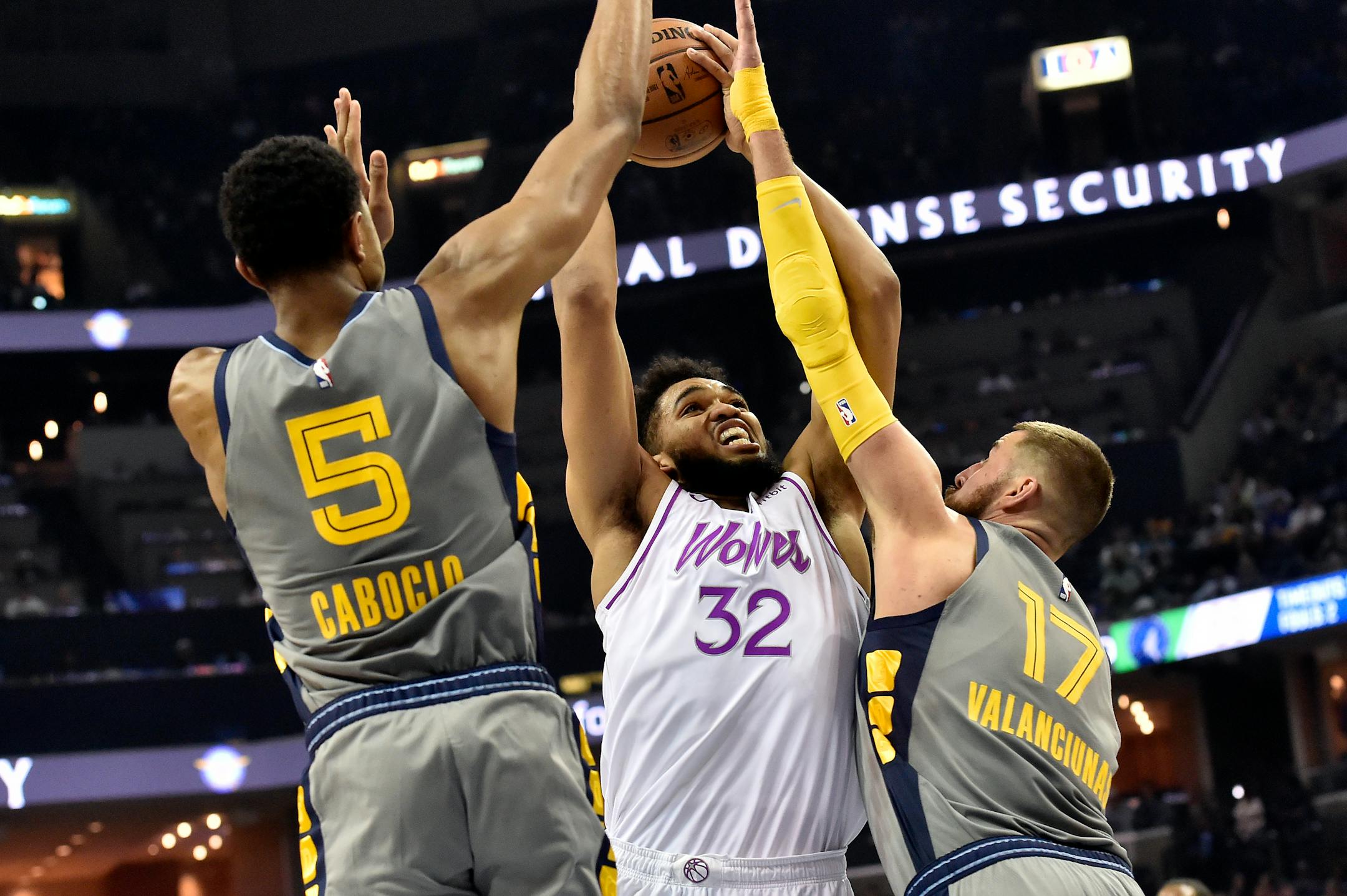 Timberwolves center Karl-Anthony Towns shoots against Memphis center Jonas Valanciunas (17) and forward Bruno Caboclo (5)