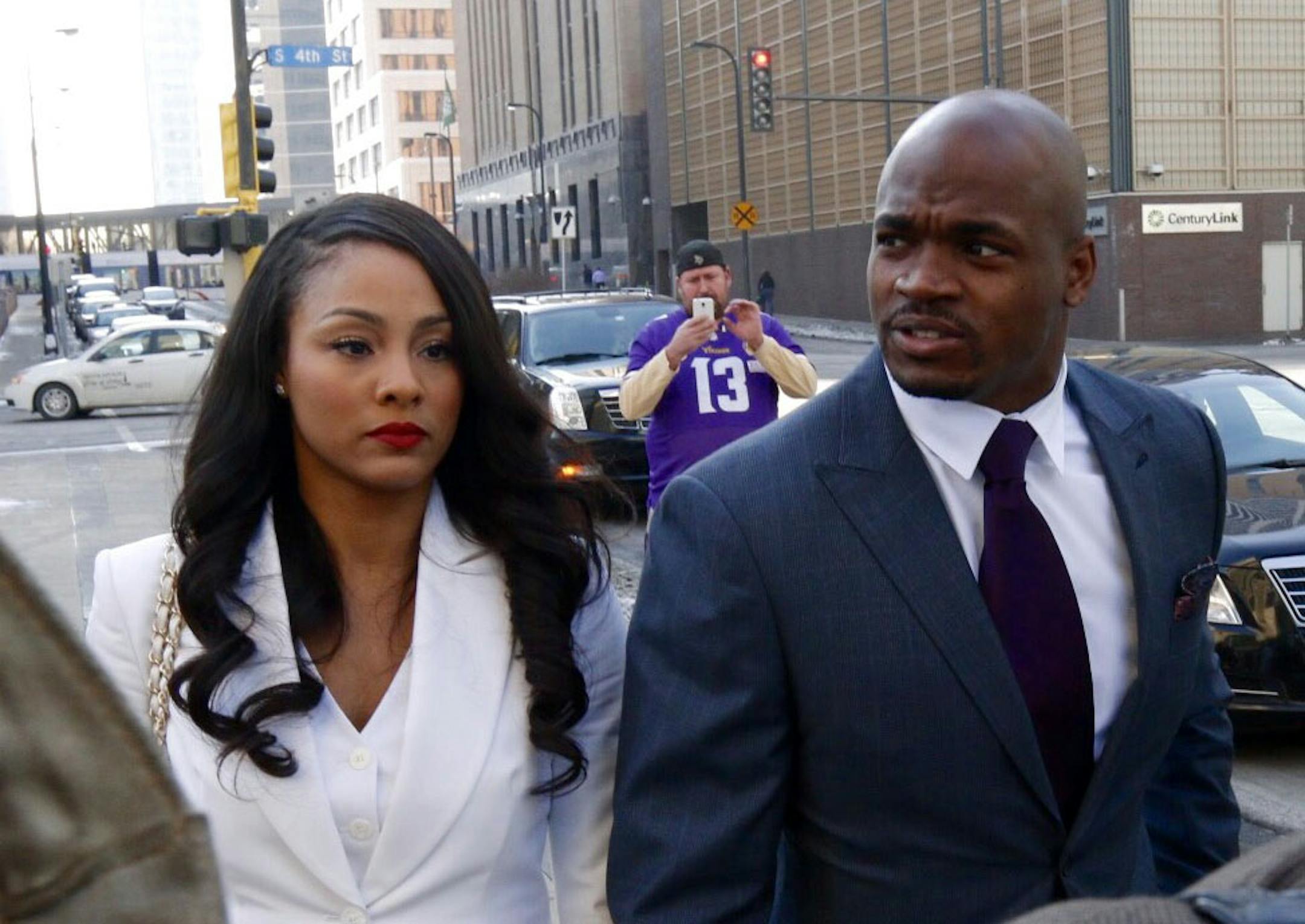 Adrian Peterson and his wife, Ashley, walk to U.S. District Court in downtown Minneapolis on Friday, Feb. 6, 2015. The hearing is the first step in a lawsuit by the NFL Players Association on behalf of Peterson contesting his suspension.