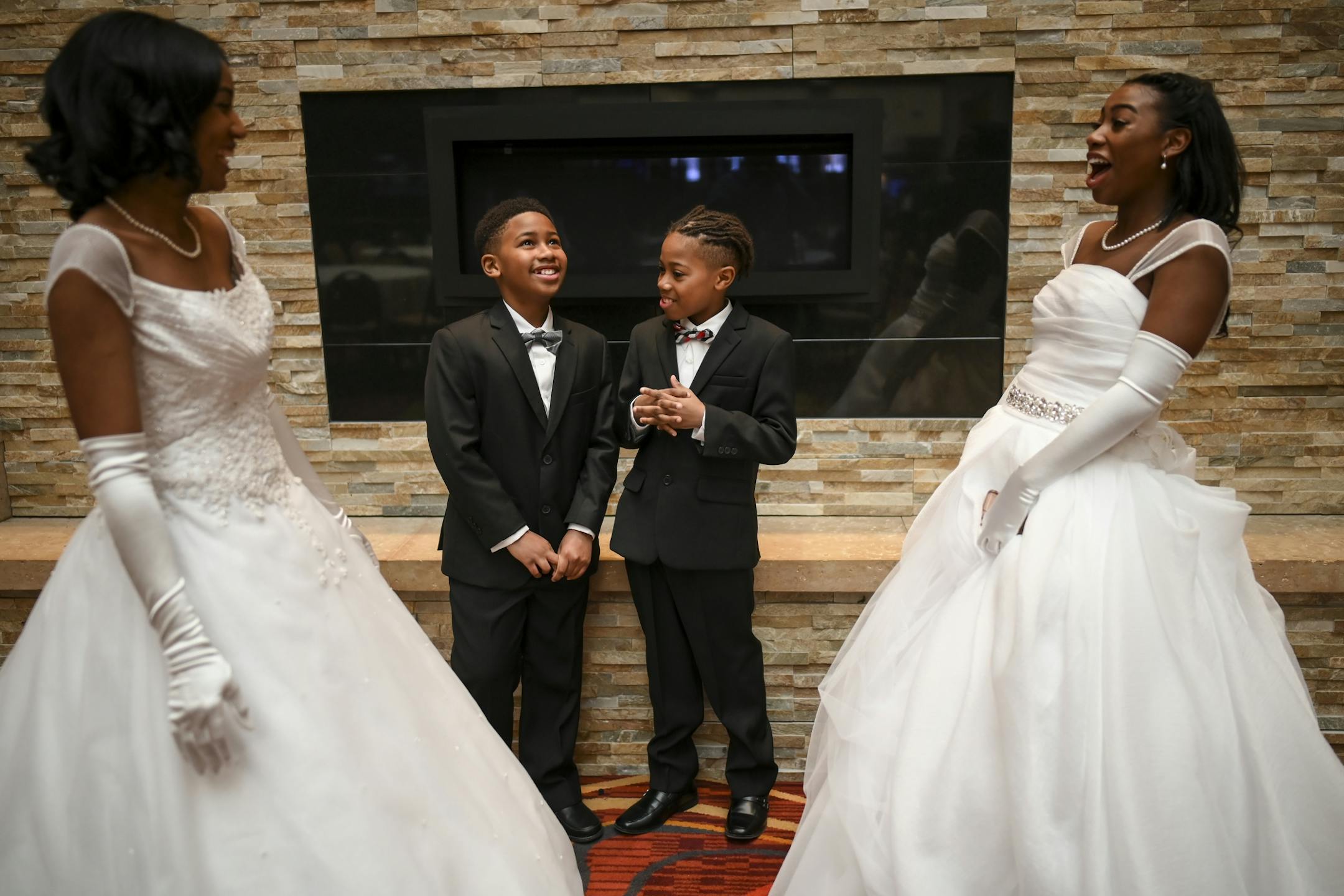 From left, Breah Banks, a junior at Benilde-St. Margaret's, brothers Talon, 9, and Braxton Green, 10, and their older sister, Nyila Green, a sophomore at Osseo, laughed before taking some photos before Saturday's cotillion.