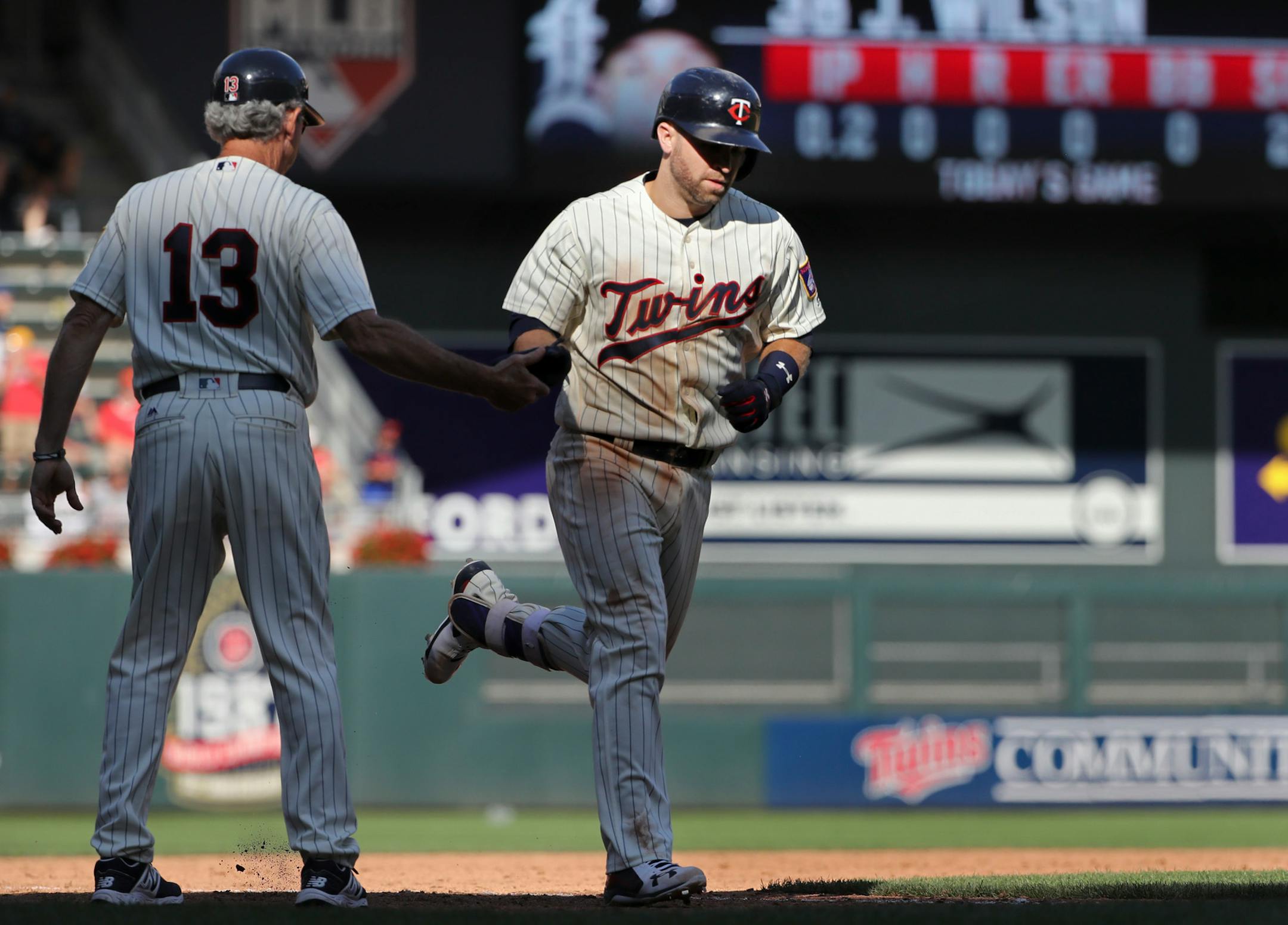 The Twins' Brian Dozier was congratulated by third base coach Gene Glynn after his solo home run to left field in the ninth inning. ] Twins vs Tigers at Target Field on 7/23/17.Richard Tsong-Taatarii/Richard Tsong-taatarii@startribune.com