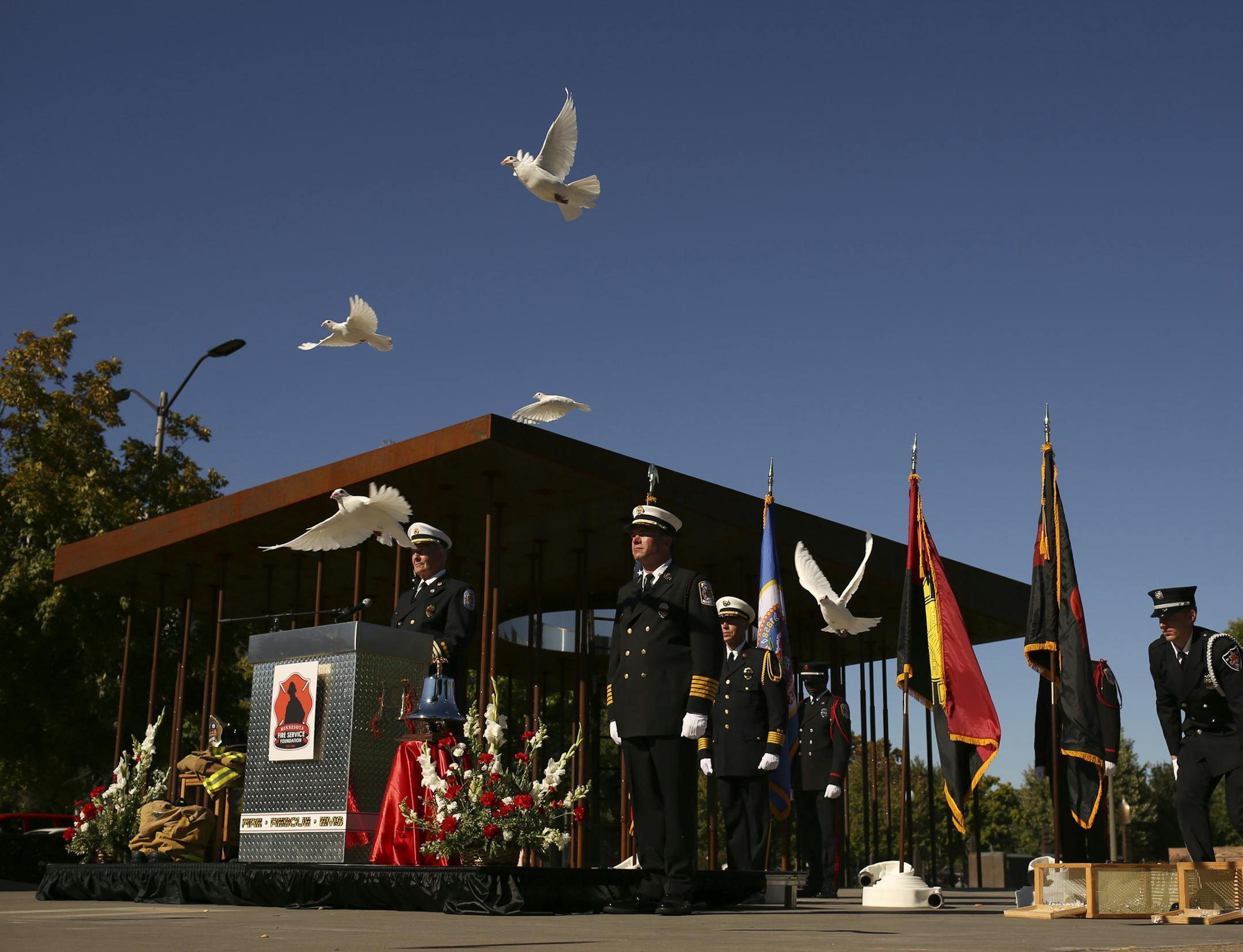 Hundreds of people attended the Minnesota Fallen Firefighter Memorial Ceremony at the monument near the State Capitol Sunday afternoon, September 29, 2013 in St. Paul. Near the end of the memorial ceremony, after the solemn tolling of the bell to honor the fallen firefighters, white doves were released. ] JEFF WHEELER ‚Ä¢ jeff.wheeler@startribune.com
