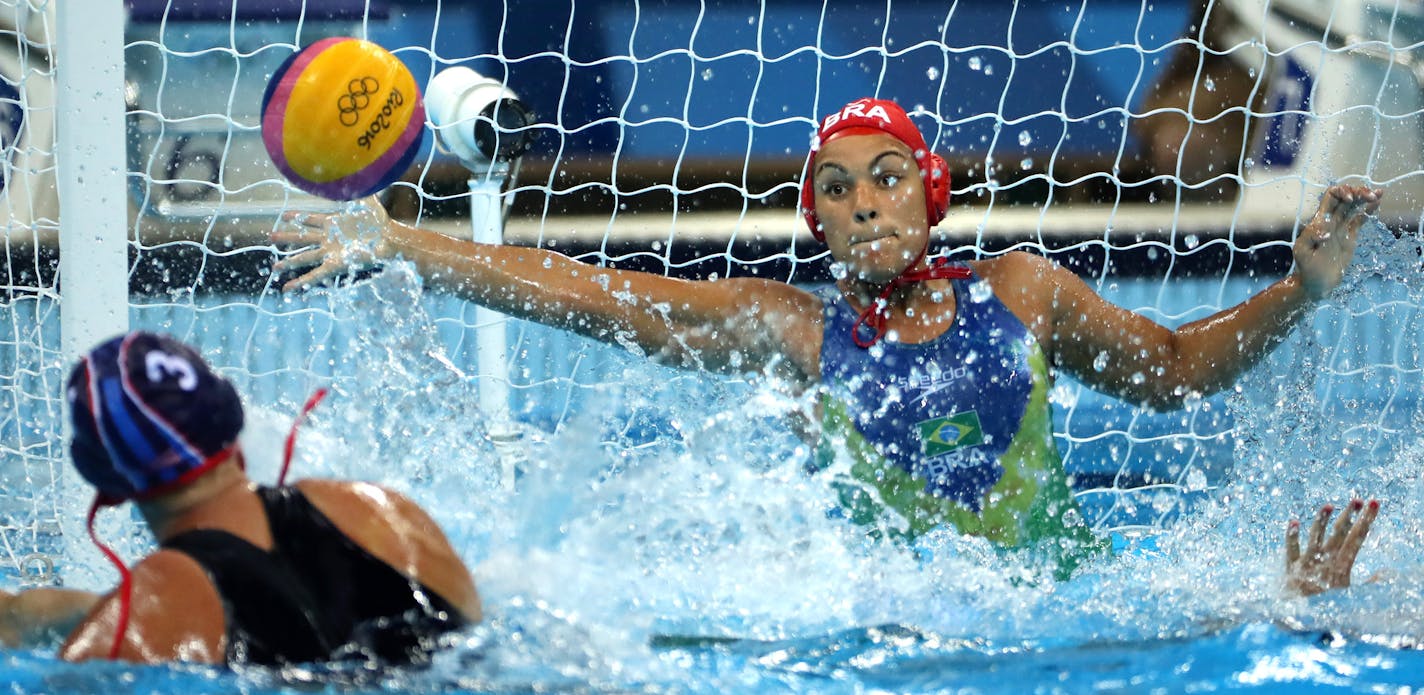 The U.S. women's water polo team secured a semifinal berth with a 13-3 victory over Brazil Monday afternoon at the Olympic Aquatics Stadium. Here, the USA's Melissa Seidemann blasted a shot past Brazil's goalie Tess Oliveira. ] 2016 Summer Olympic Games - Rio Brazil brian.peterson@startribune.com Rio de Janeiro, Brazil - 08/15/2016