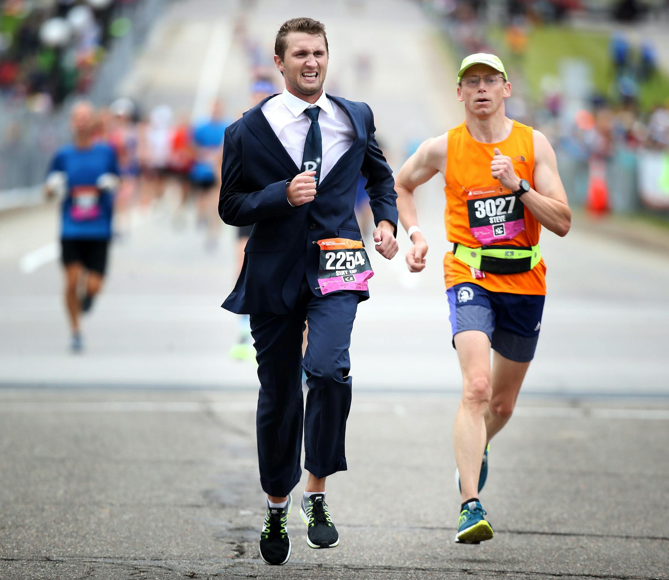 Steve Dado of Stillwater, wore a business suit at the finish line during the Twins Cities Marathon Sunday October 1,2017 in St. Paul, MN. ] JERRY HOLT ï jerry.holt@startribune.com Jerry Holt