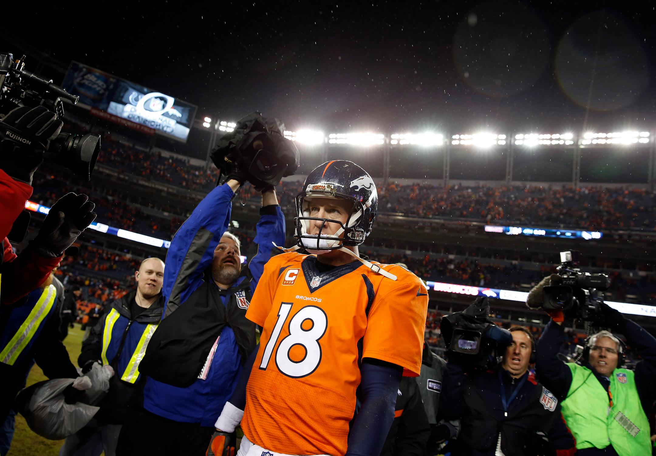 Denver Broncos quarterback Peyton Manning (18) leaves the field after an NFL divisional playoff football game against the Indianapolis Colts, Sunday, Jan. 11, 2015, in Denver. The Colts won 24-13 to advance to the AFC Championship game against the New England Patriots. (AP Photo/David Zalubowski)