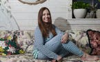 Lauren Raja, founder of Justin & Jean Pajamas, poses for a photograph wearing her designed ruffled bottomed PJs at the The White Dog Cafe in Philadelp