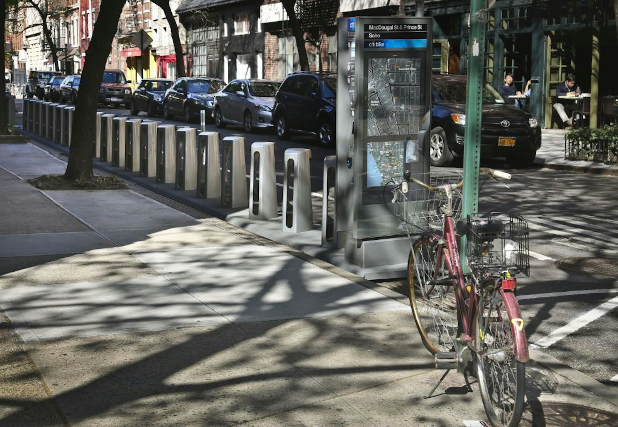 In this Wednesday, May 1, 2013 photo, docks for a new bike share program stand empty on MacDougal Street in New York. This month, New York will join the ranks of Paris, London, Madrid and Washington by enacting its first-ever bike share program.