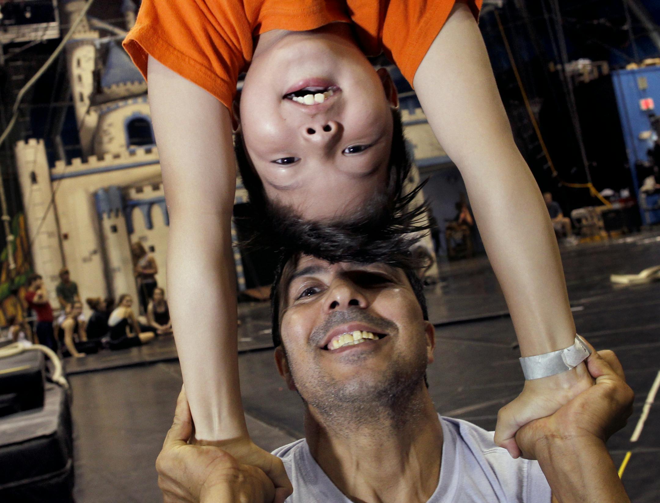 St. Paul&#x201a;&#xc4;&#xf4;s Circus Juventas performers, including, Anwar Hassouni, the Frog Prince, being held by coach father, Mostapha Hassouni, will take part in the fairytale remix: "Grimm: Happily Ever After." About six dozen, out of 800, student acrobats and gymnasts will take part in the show.] TOM WALLACE &#x201a;&#xc4;&#xa2; twallace@startribune.com __Assignments #20018789A_ July 18, 2011_ SLUG: stag0729_ EXTRA INFORMATION : (CQ) Jerome 'JT' Scott, (CQ) Anwar Hassouni and (CQ) Libby U