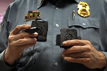 Minneapolis Police Lt. Greg Reinhardt displayed two of the body cameras that will be tested by the department. Both cameras will record 9.5 hours of v