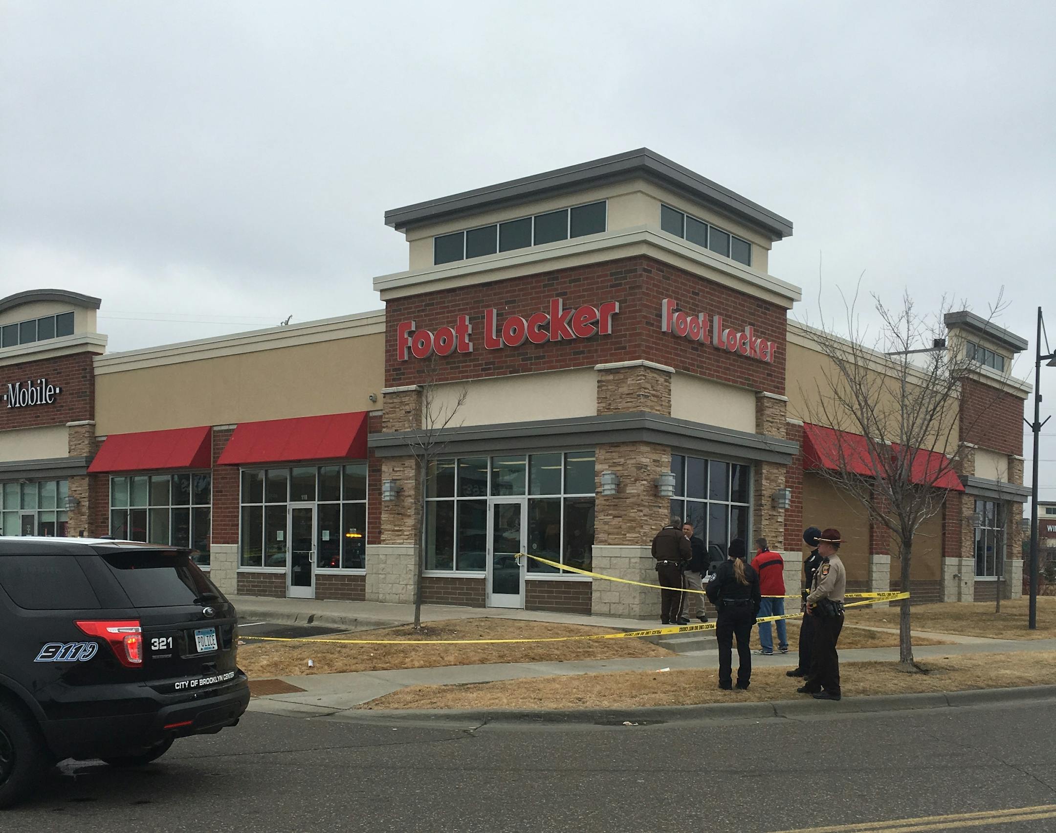 Police investigate Saturday after a shooting at a shopping center in Brooklyn Center.