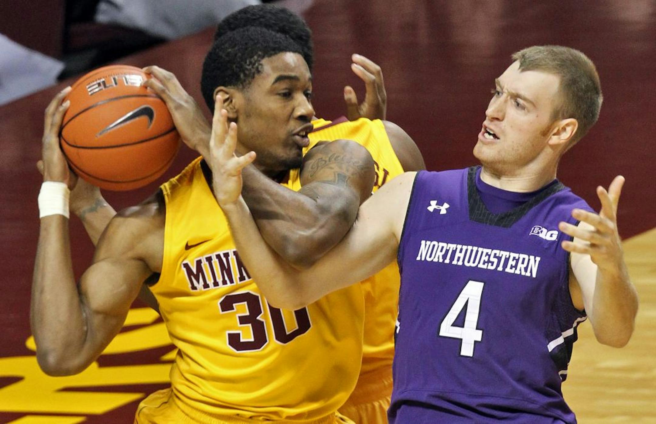 Minnesota's Andre Ingram (30) and Northwestern's Alex Marcotullio fought for control of a rebound.