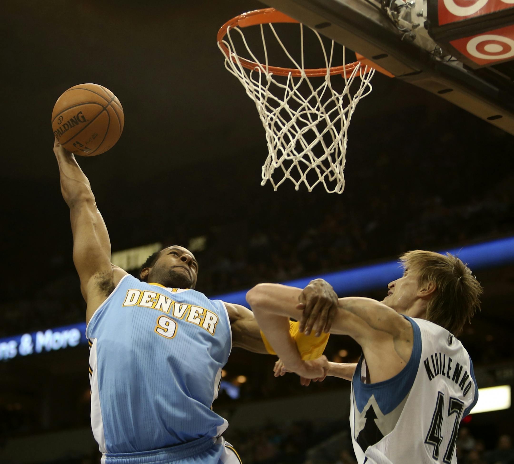 Nuggets Andre Iguodala reached back before making a dunk with Timberwolves Andrei Kirilenko during second half action at Target Center in Minneapolis Min., Wednesday November 21, 2012. Nuggets won 101-94