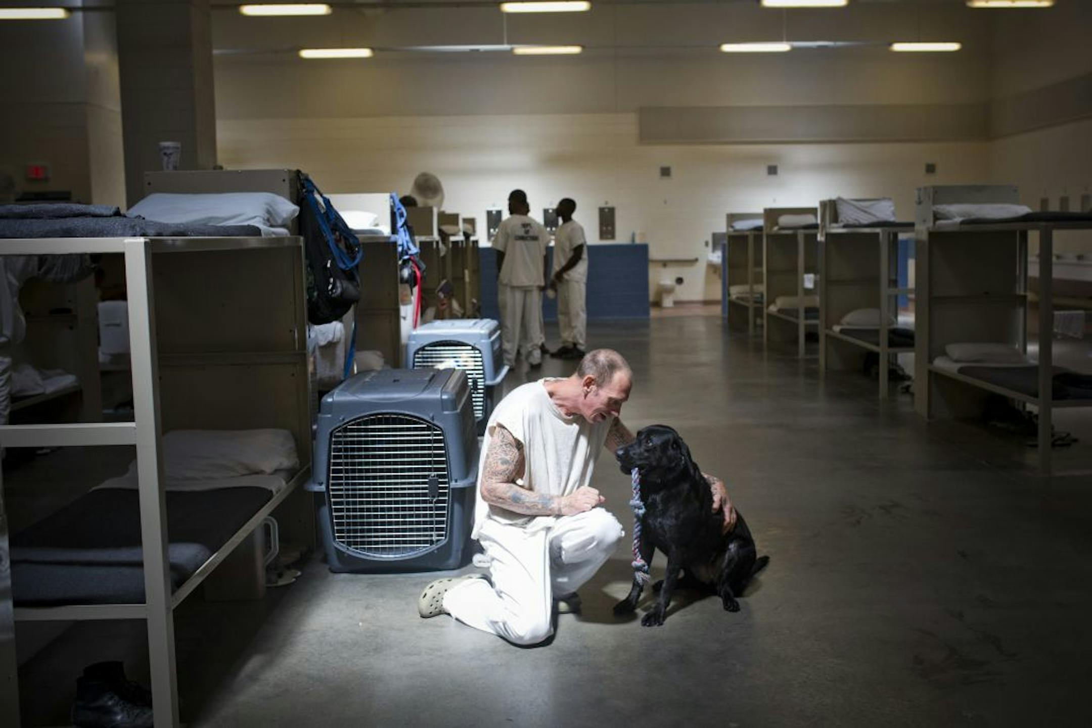 An inmate and his dog at Coffee Prison, where there is a training program to teach dogs to sniff out bombs, narcotics or other threats, in Nichols, Ga., July 9, 2015. The program, run by Auburn University, breeds and trains the dogs with help from inmates, before they�re probably placed with a government agency or a private security firm. (Bryan Meltz/The New York Times) -- STAND ALONE IMAGE -- FOR USE AS DESIRED IN ROUNDING UP THE YEAR THAT WAS 2015 --