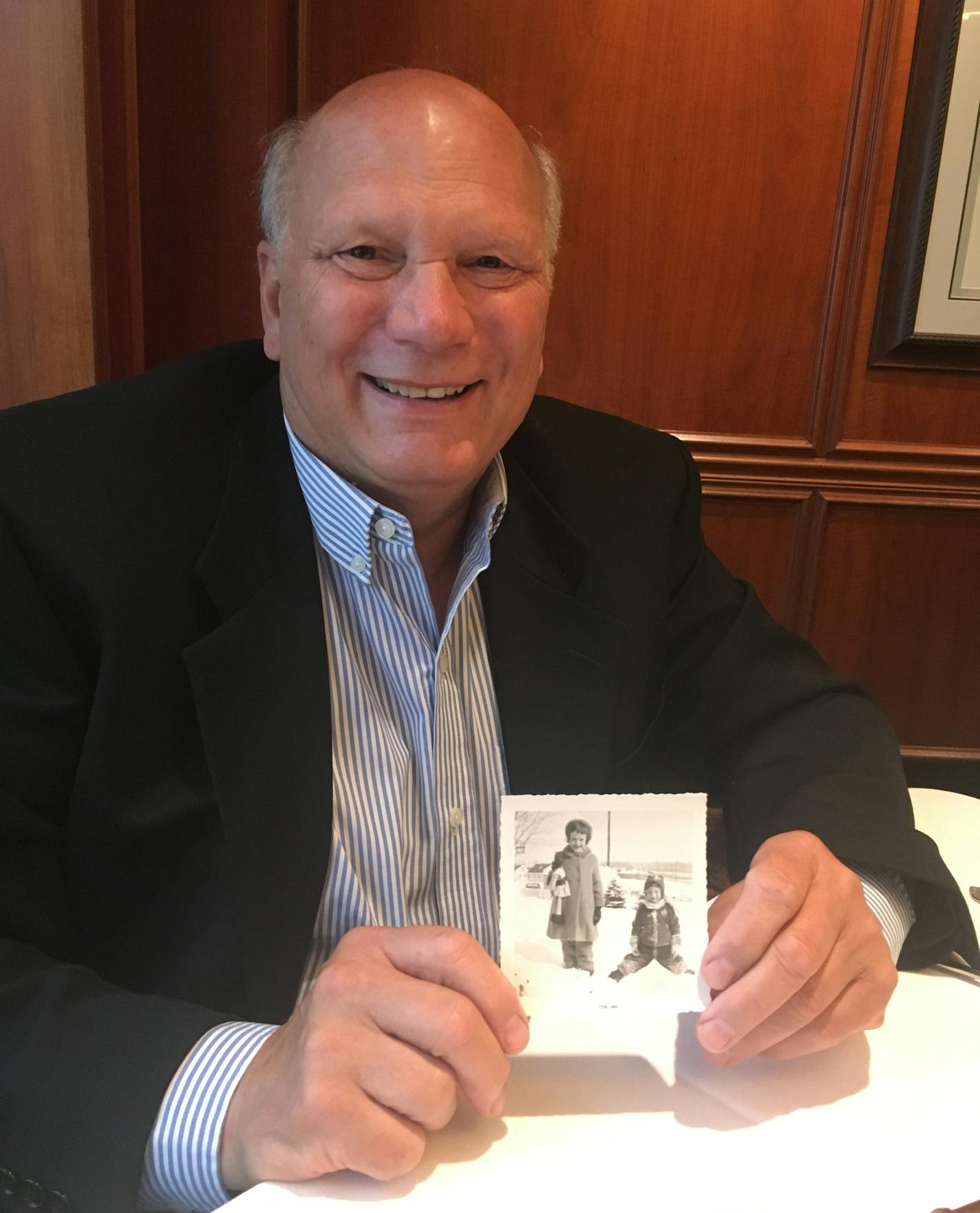 Mark Kozlak holds a photo of himself and Janet Lee Dahl, taken in 1955 by Janet's mother, Gertrude.