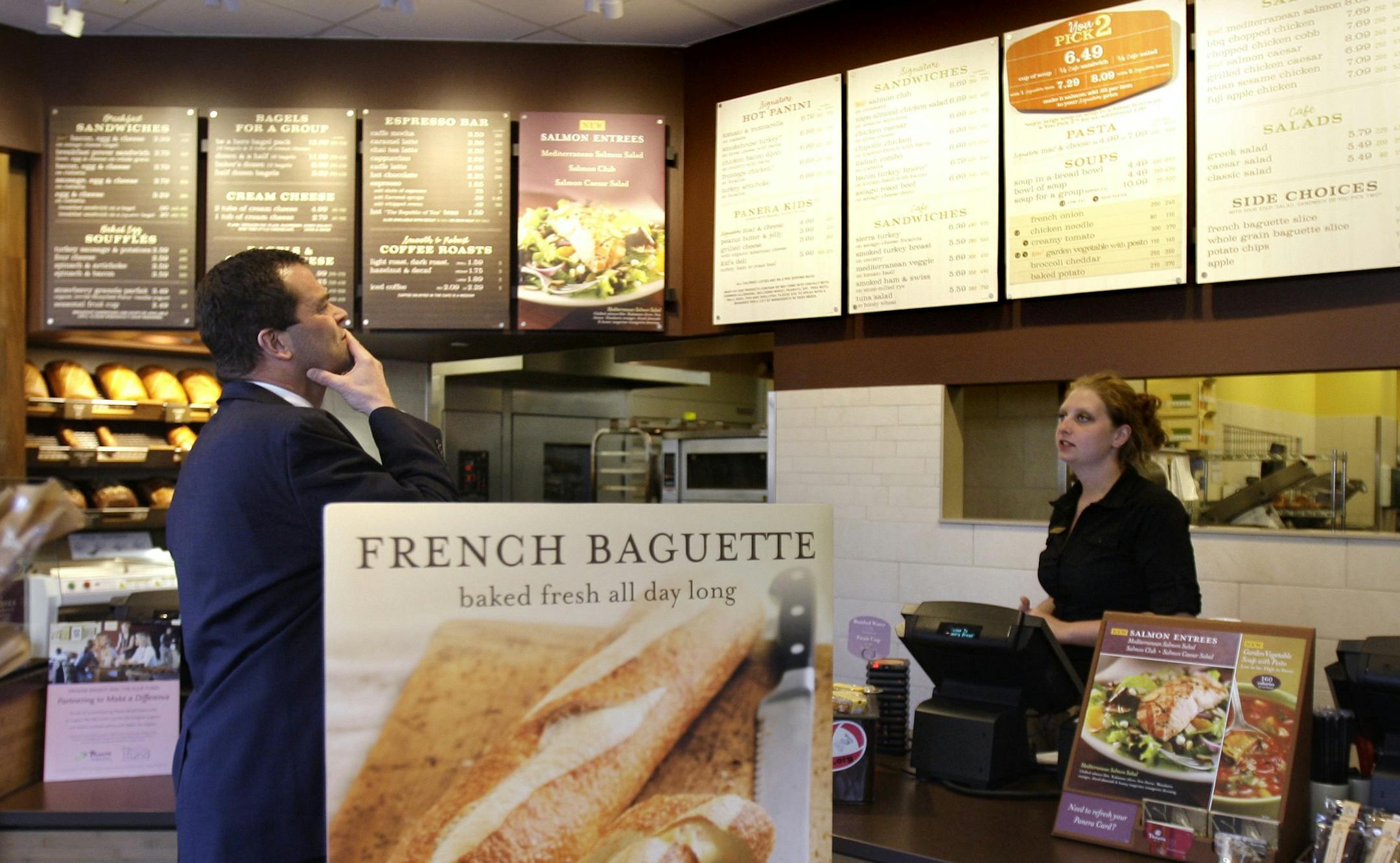 FILE - In this March 8, 2010 file photo, a customer reviews the sandwich board at the Panera store in Brookline, Mass.