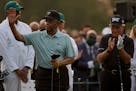 Lee Elder waves with Gary Player before the ceremonial first tee the first round of the Masters golf tournament on Thursday, April 8, 2021, in Augusta