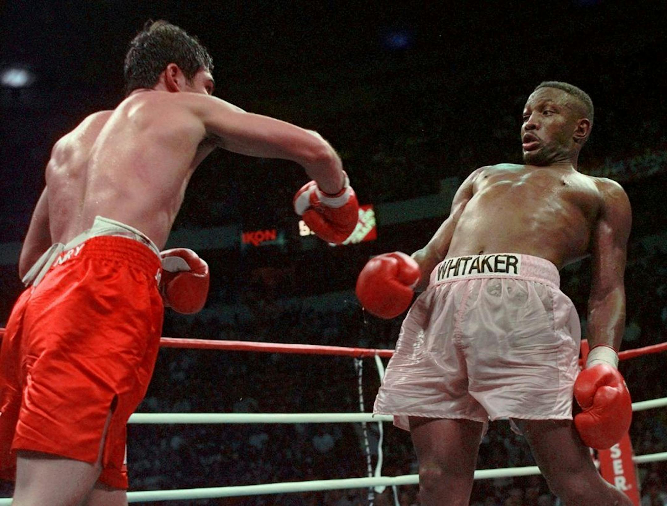 In this April 12, 1997, file photo, Pernell Whitaker, right, leans away from a punch by Oscar De La Hoya during their WBC Welterweight Championship fight at Thomas & Mack Center in Las Vegas.