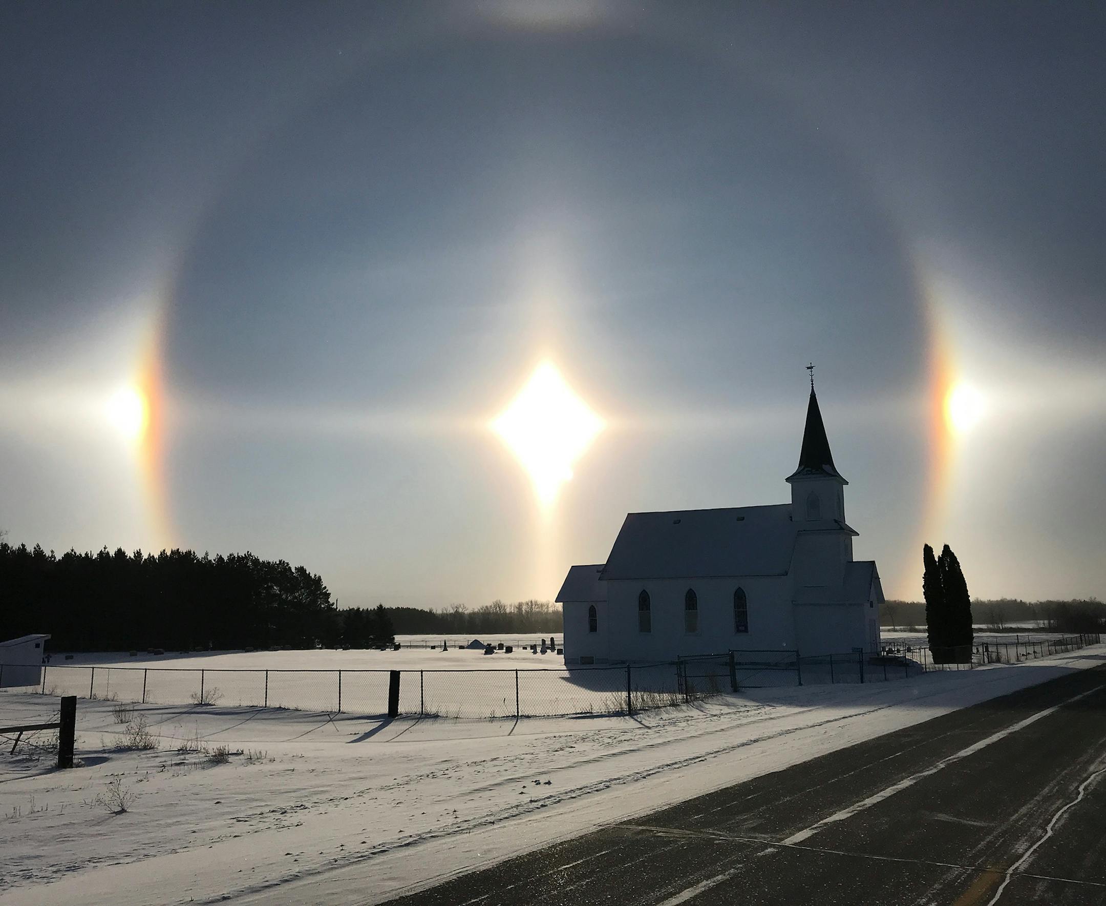 Karl Reichert of Minneapolis took this photo Christmas morning. "The sun dogs were magnificent in Clearwater County ... when it was about -22 degrees. In fact, I have never recalled seeing sun dogs this brilliant in my life," says Karl, who has photographed Seljord Lutheran Church many times over the years, and as a kid could see the church from his bedroom window. [focus020418