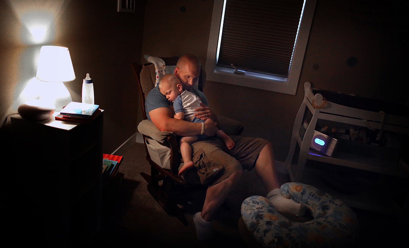 35W bridge collapse survivor Garrett Ebling rocked his 16-month-old son, Cooper, to sleep at his Andover home.