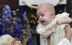 Swedish Arch Bishop Antje Jackelen raises Prince Nicolas during his christening ceremony, at the Drottningholm Palace Church, near Stockholm, Sweden, 