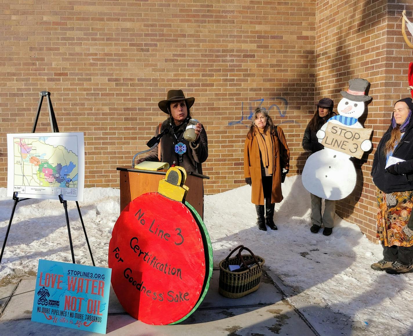 Winona LaDuke, executive director of activist group Honor the Earth, holds a jar of oil and water recovered from the 2010 Kalamazoo River spill in Michigan as she makes the case against the Enbridge Line 3 replacement pipeline in Duluth on Thursday.