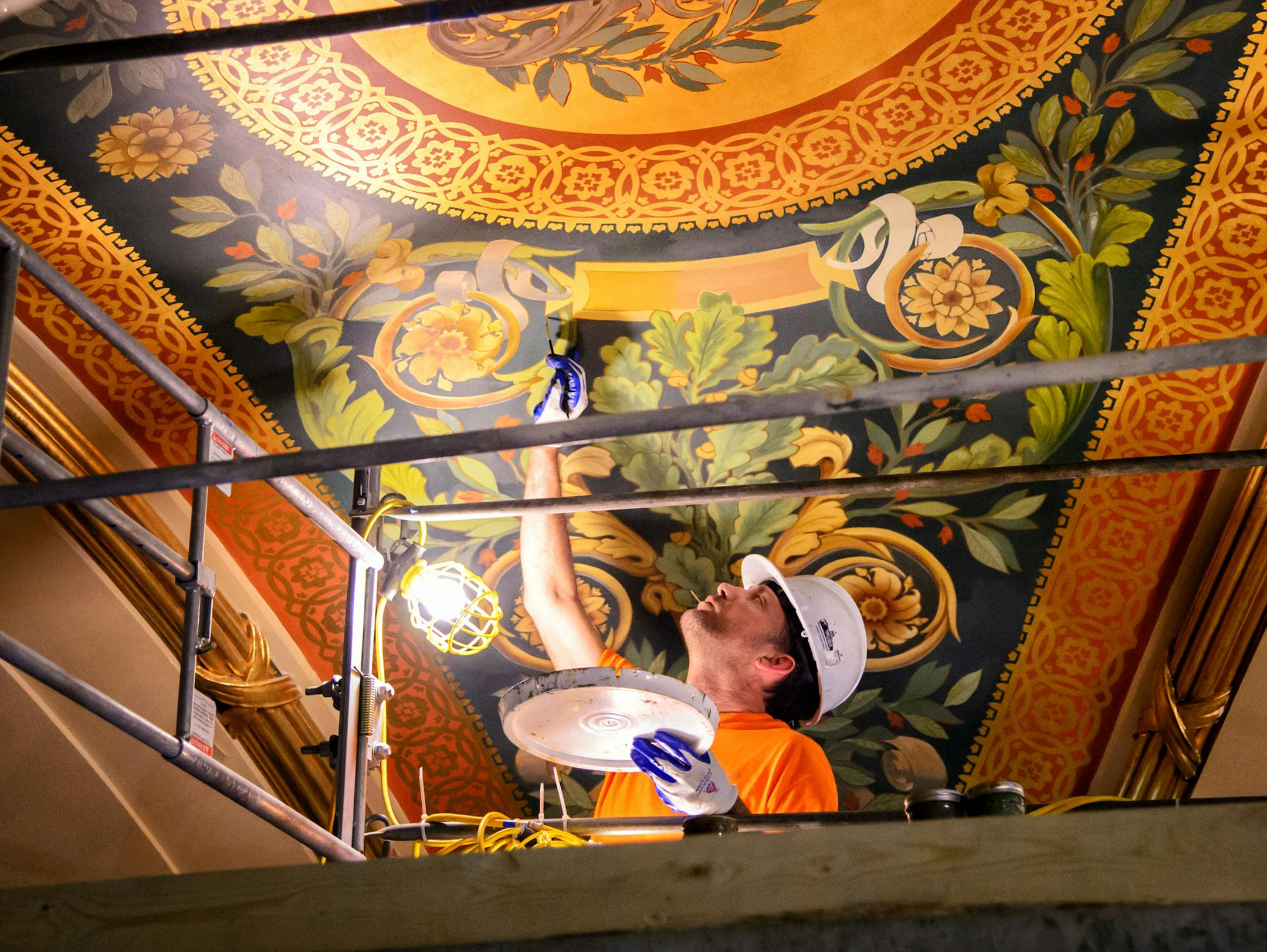 Workers from Conrad Schmitt Studios, a restoration company out of New Berlin, Wisconsin, are painstakingly restoring the murals and gold leaf on the upper level of the Minnesota House Chamber. ] GLEN STUBBE * gstubbe@startribune.com Thursday September 10, 2015