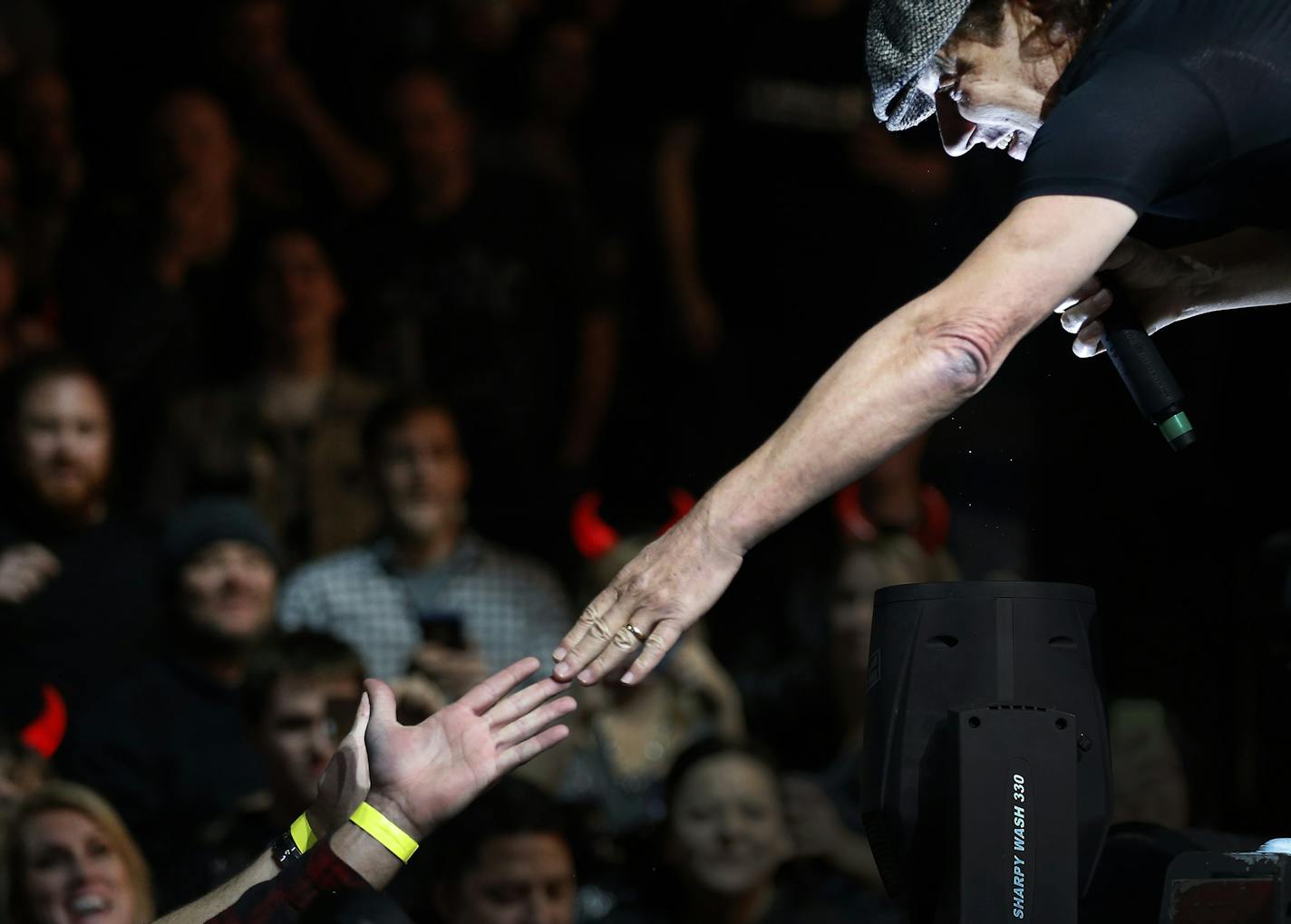 Lead singer Brian Johnson reached out to a fan as AC/DC performed at the Xcel Energy Center on Sunday night. ] CARLOS GONZALEZ cgonzalez@startribune.com - February 14, 2016, New St. Paul, MN, Xcel Energy Center, AC/DC Concert