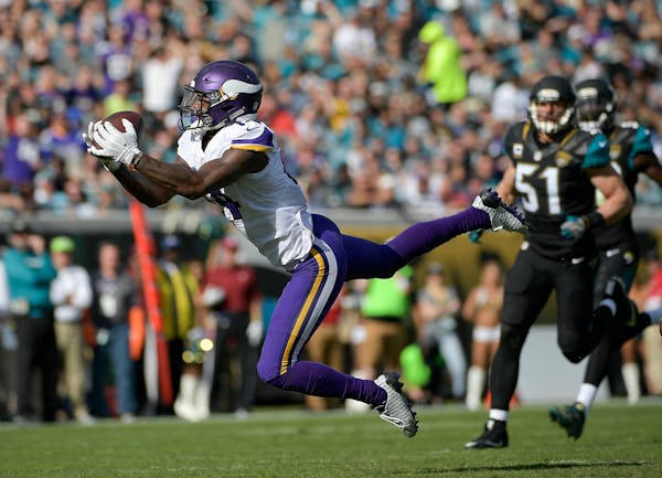 Minnesota Vikings wide receiver Stefon Diggs, left, catches a pass in front of Jacksonville Jaguars middle linebacker Paul Posluszny (51) during the f