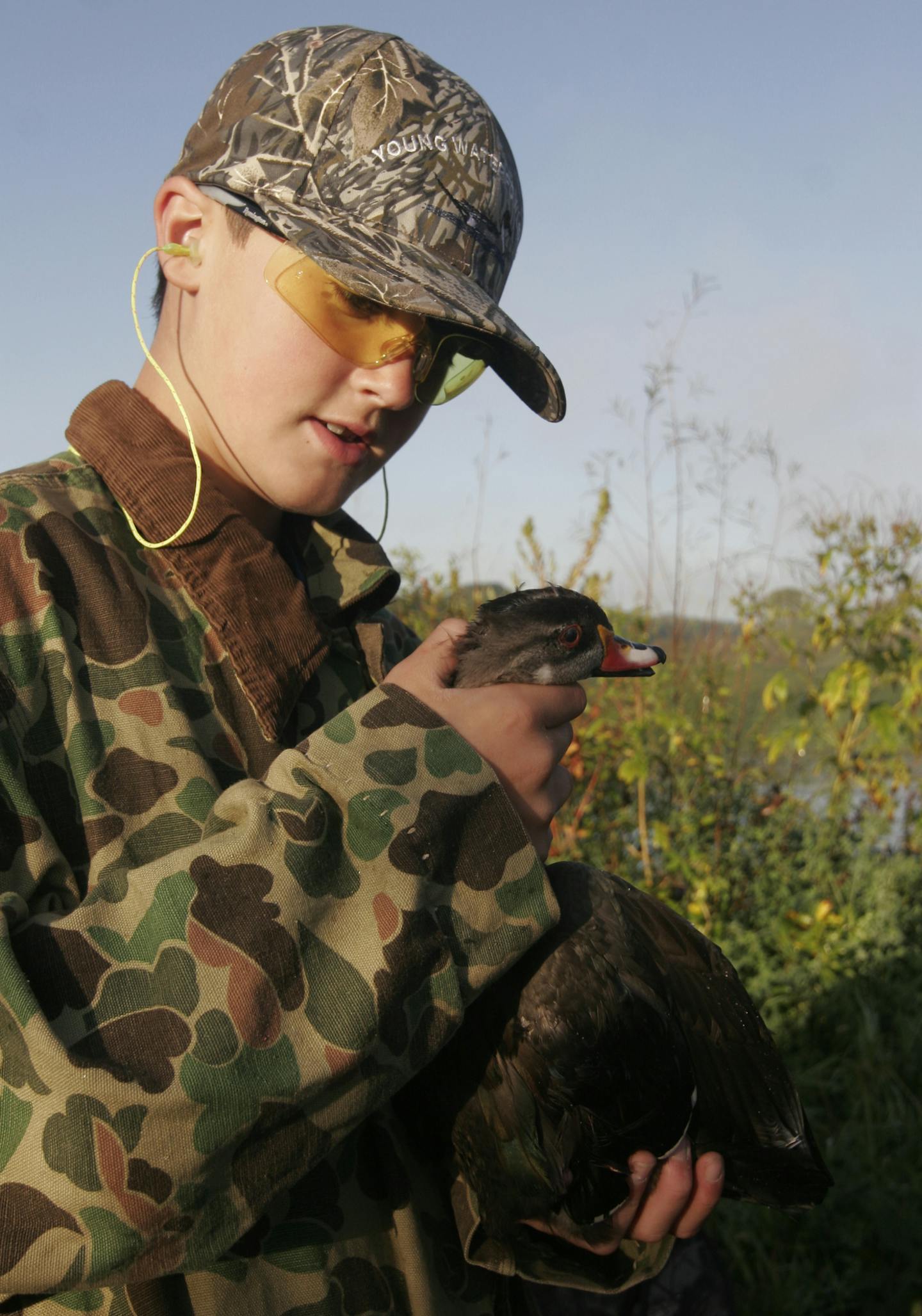 Gabe Olson, 11, examined a wood duck he and his brother, Sam, shot Saturday during Youth Waterfowl Day.