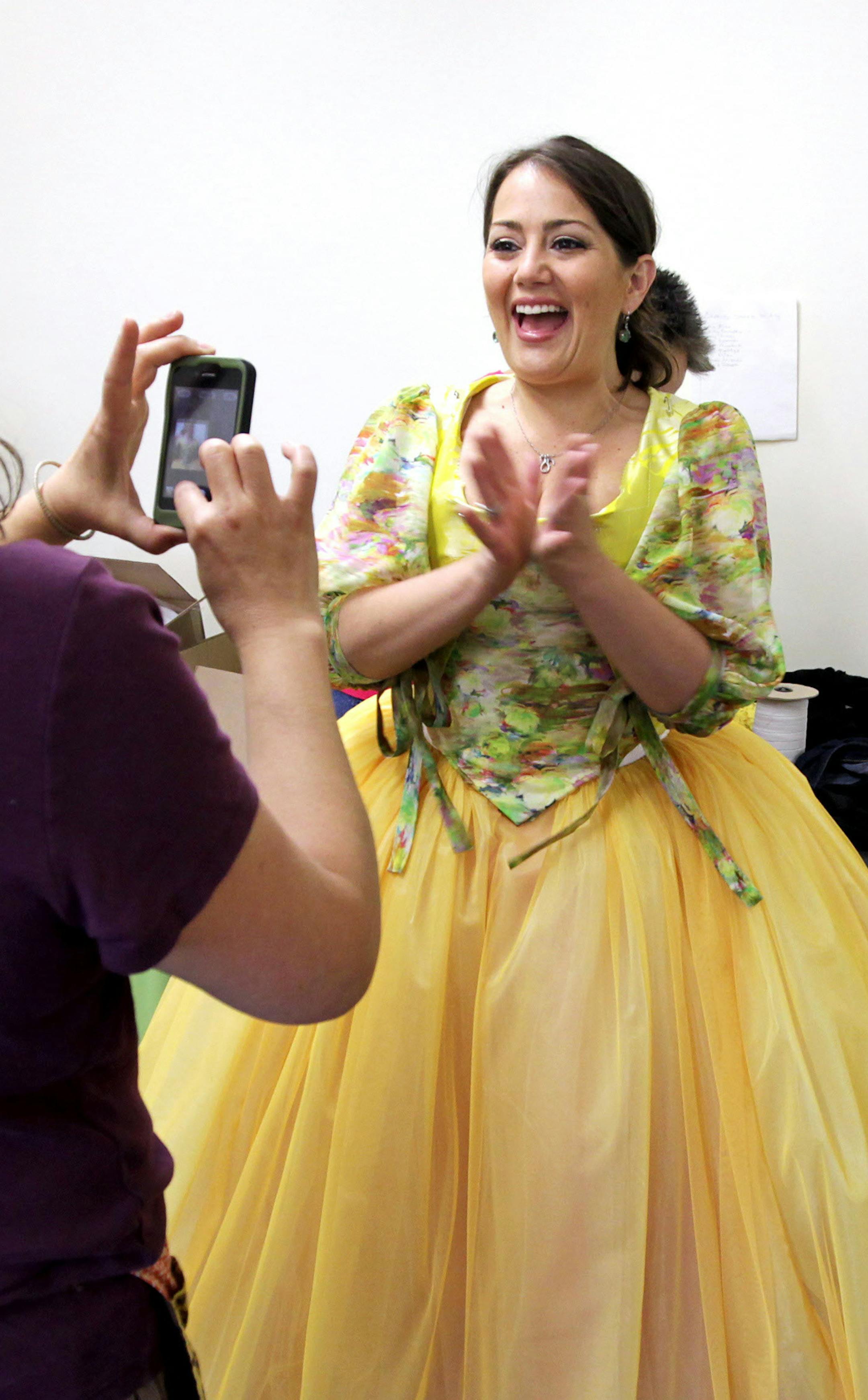 Opera singer Heather Johnson, right, shows her enthusiasm for a dress design during a costume fitting with Ellen Roeder at Tulle and Dye in St. Paul June 29, 2013. Johnson grew up in White Bear Lake, attended St. Olaf College, and now lives in New York City. She will be playing Rosina in "The Barber of Seville" at the Mill City Opera. (Courtney Perry/Special to the Star Tribune) ORG XMIT: MIN1307011125530658