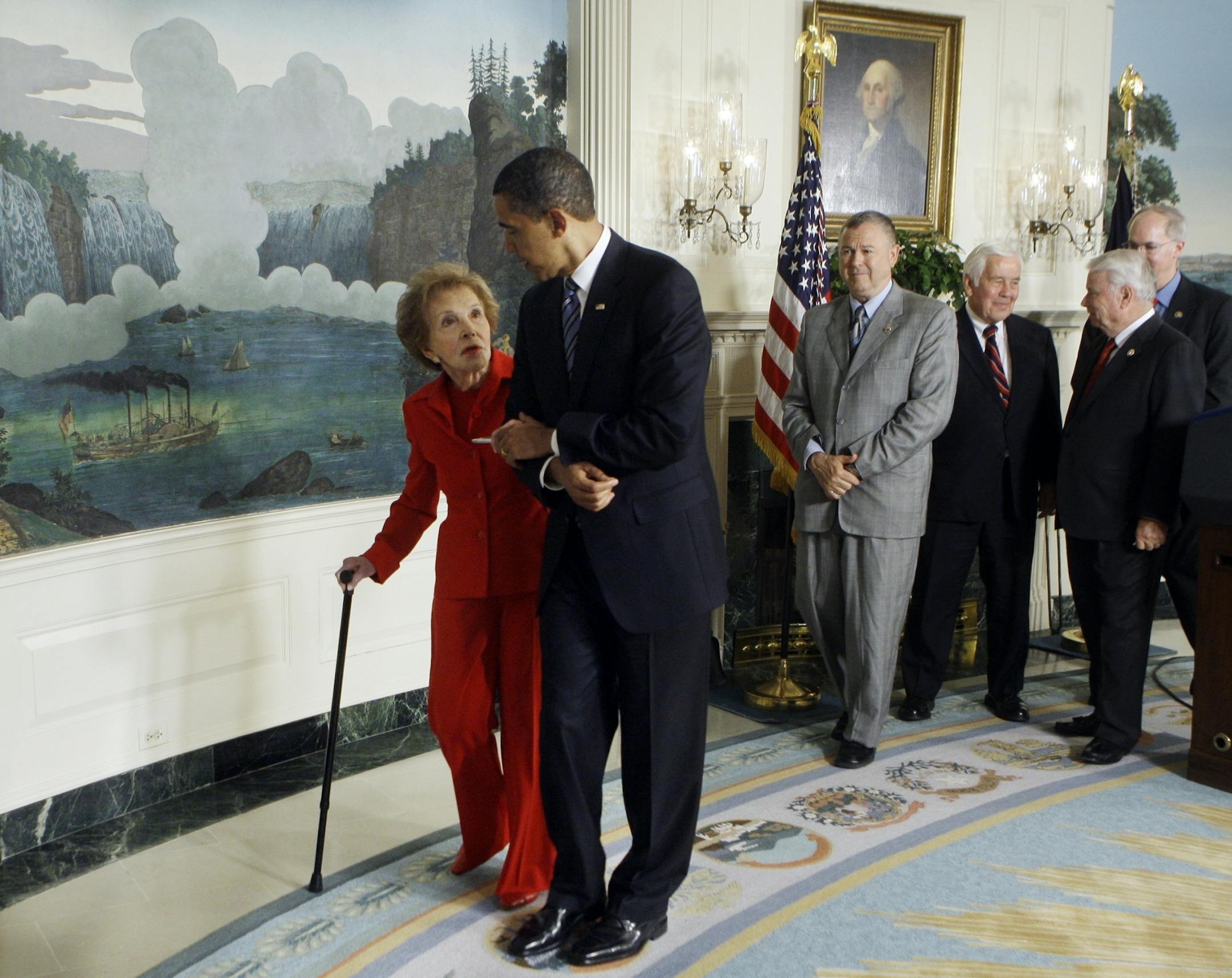 FILE - In this June 2, 2009, file photo, President Barack Obama escorts former first lady Nancy Reagan after signing the Ronald Reagan Centennial Commission Act, during a ceremony in the Diplomatic Reception Room of the White House in Washington. The former first lady has died at 94, The Associated Press confirmed Sunday, March 6, 2016.