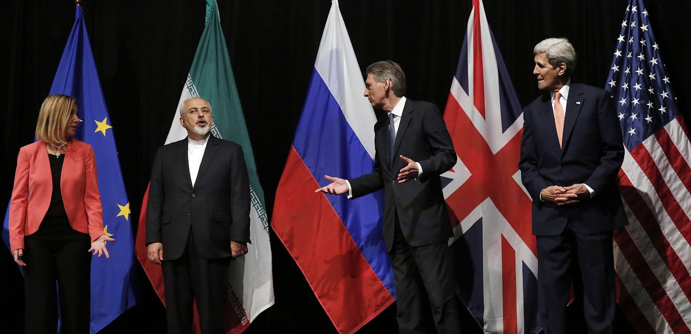 British Foreign Secretary Philip Hammond, 2nd right, U.S. Secretary of State John Kerry, right, and European Union High Representative for Foreign Affairs and Security Policy Federica Mogherini, left, talk to Iranian Foreign Minister Mohammad Javad Zarif as the wait for Russian Foreign Minister Sergey Lavrov, not pictured, for a group picture at the Vienna International Center in Vienna, Austria, Tuesday, July 14, 2015. After 18 days of intense and often fractious negotiation, world powers and I