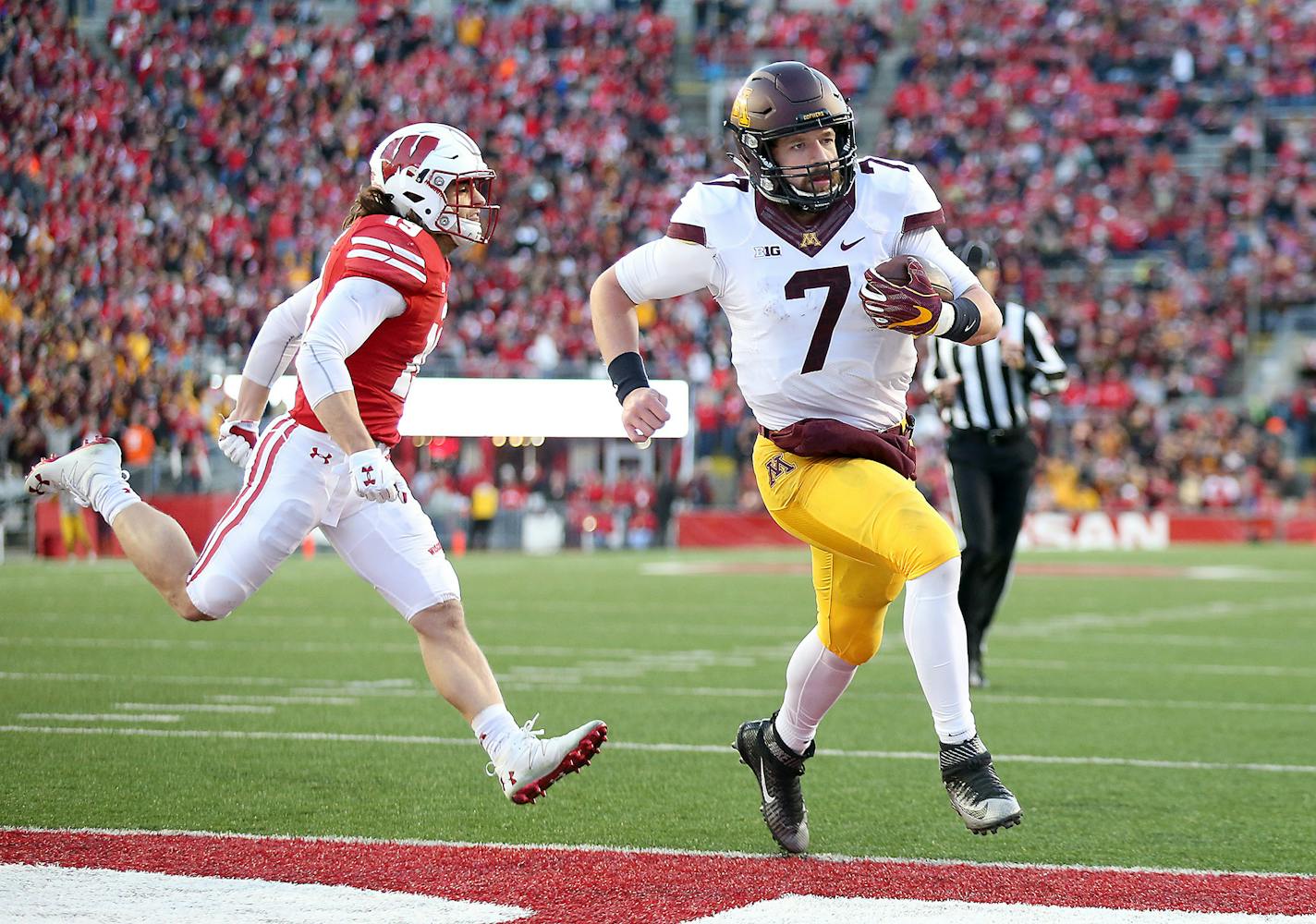 Wisconsin safety Leo Musso couldn't catch Gophers quarterback Mitch Leidner as he ran into the end zone for a touchdown in the second quarter at Camp Randall Stadium on Nov. 26.