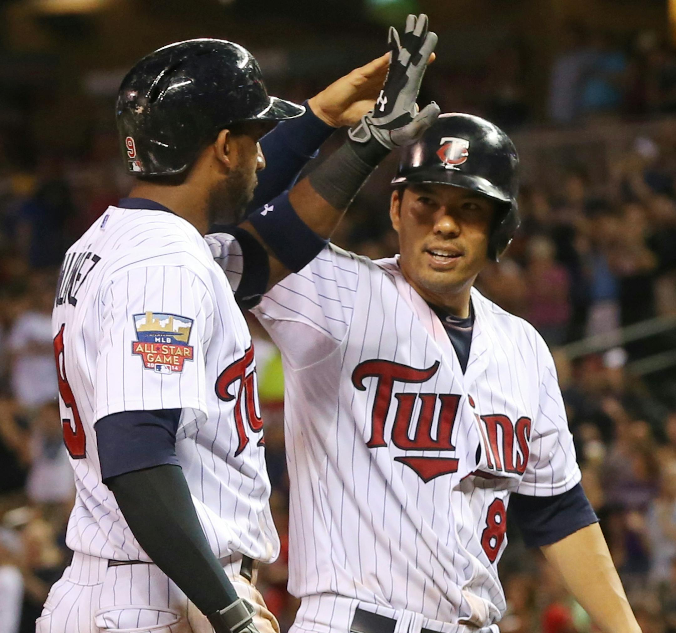 Minnesota Twins' Kurt Suzuki, right, congratulates Eduardo Nunez after Nunez' three-run home run to tie the baseball game in the sixth inning off Los Angeles Angels pitcher Hector Santiago, Thursday, Sept. 4, 2014, in Minneapolis. (AP Photo/Jim Mone)