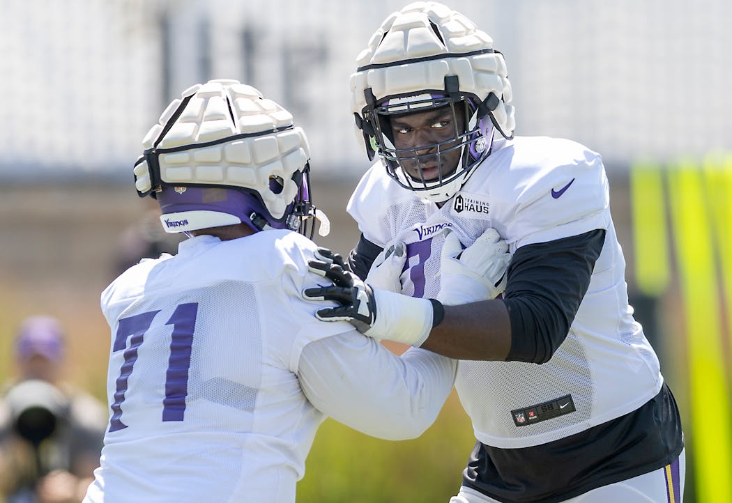 Vikings Offensive Guard Olisaemeka Udoh practiced with left tackle Christian Darrisaw (right) during training camp.